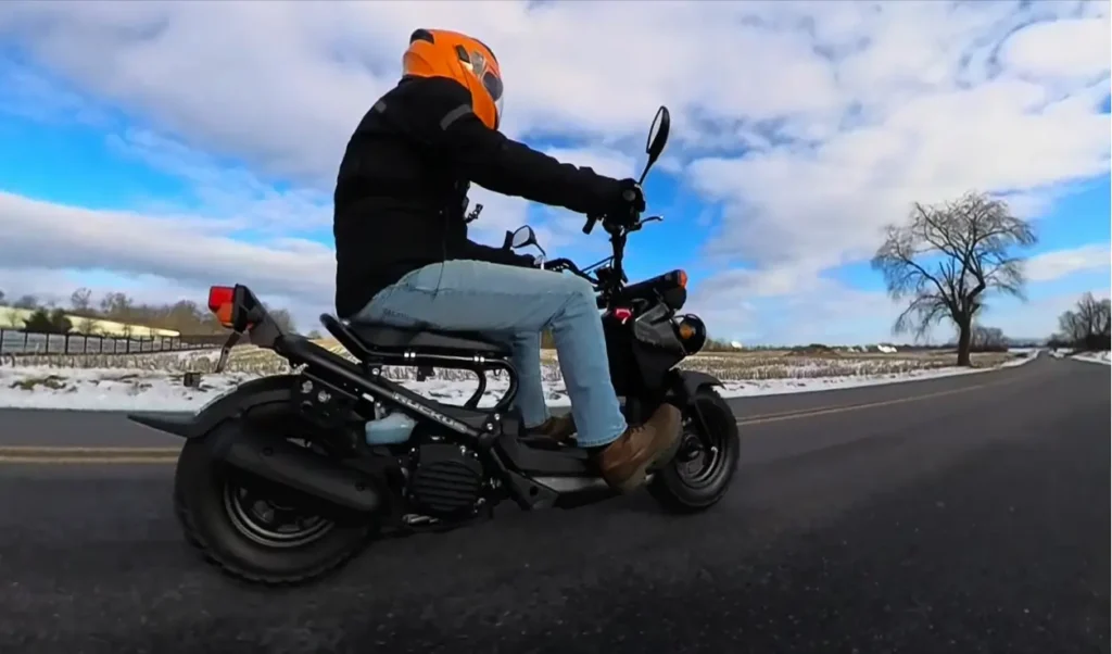 a man riding a honda ruckus