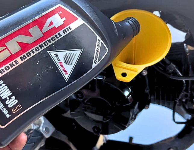 adding new GN4 oil on a honda grom